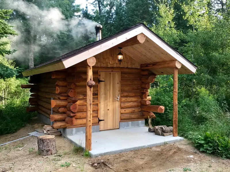 Small log sauna with a covered entry