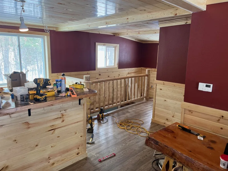 Kitchen with wood cabinets and a log ceiling beam