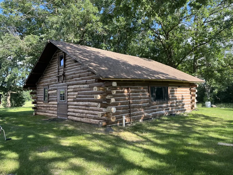 Weathered log cabin with a shingled roof