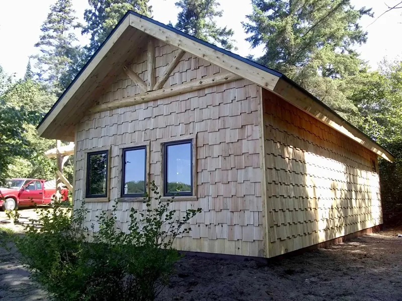 Log-sided cabin with purple-trimmed windows